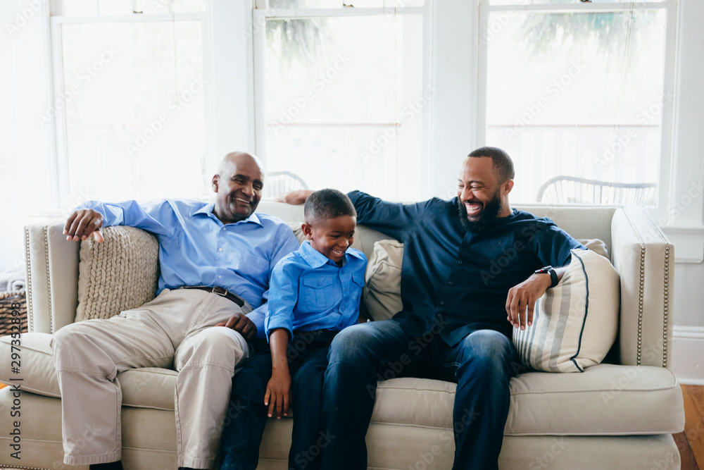 Grandfather, son, and grandson sitting together at home Grandfather, son, and grandson sitting together at home