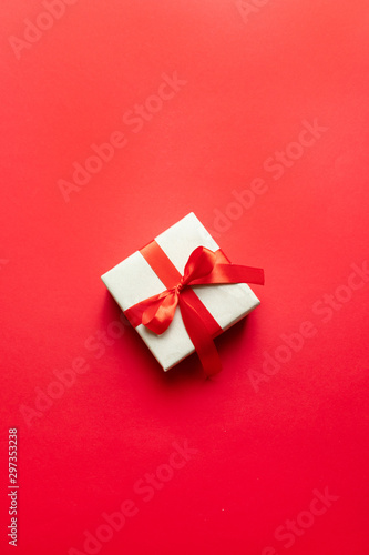 Minimal New Year concept. Christmas composition with festive red craft box and red ribbon