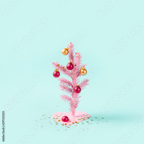 Painted Christmas tree decorated with red and golden balls. Paint flows and forms puddle. Minimal holiday concept