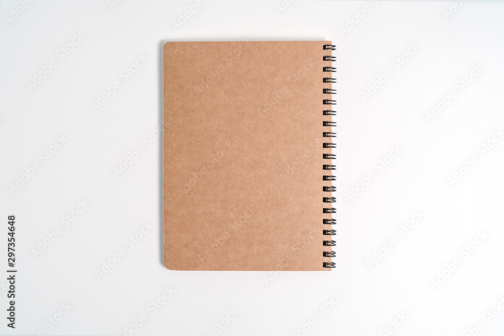 Fototapeta premium Brown spiral notebook isolated on white background.top view