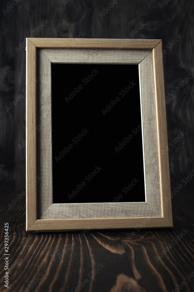 Naklejka premium Vintage photo frame on wooden table