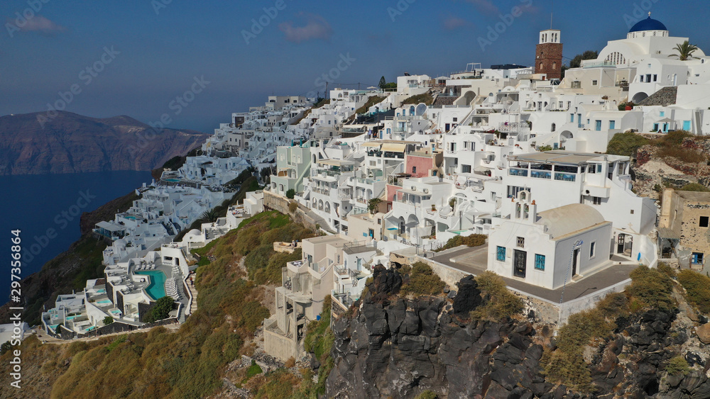 Aerial drone photo of iconic picturesque village of Imerovigli built on top of steep hill with amazing views to Caldera and Santorini island, Cyclades, Greece