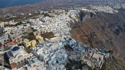 Aerial drone photo of iconic picturesque village of Imerovigli built on top of steep hill with amazing views to Caldera and Santorini island, Cyclades, Greece © aerial-drone