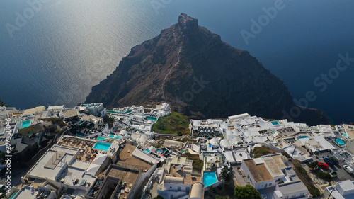 Aerial drone photo of iconic picturesque village of Imerovigli built on top of steep hill with amazing views to Caldera and Santorini island, Cyclades, Greece photo