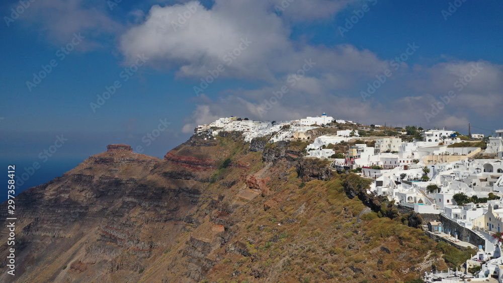 Naklejka premium Aerial drone photo of iconic picturesque village of Imerovigli built on top of steep hill with amazing views to Caldera and Santorini island, Cyclades, Greece