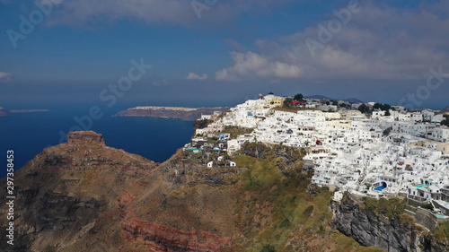 Aerial drone photo of iconic picturesque village of Imerovigli built on top of steep hill with amazing views to Caldera and Santorini island, Cyclades, Greece © aerial-drone