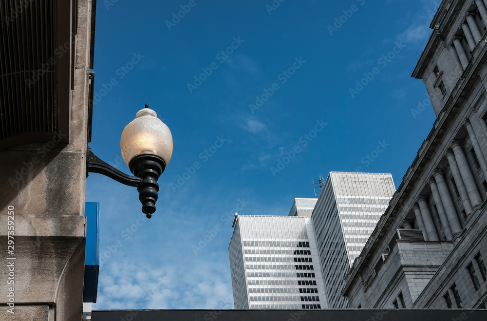 Architecture lantern seen switched on during daylight in a North American city.