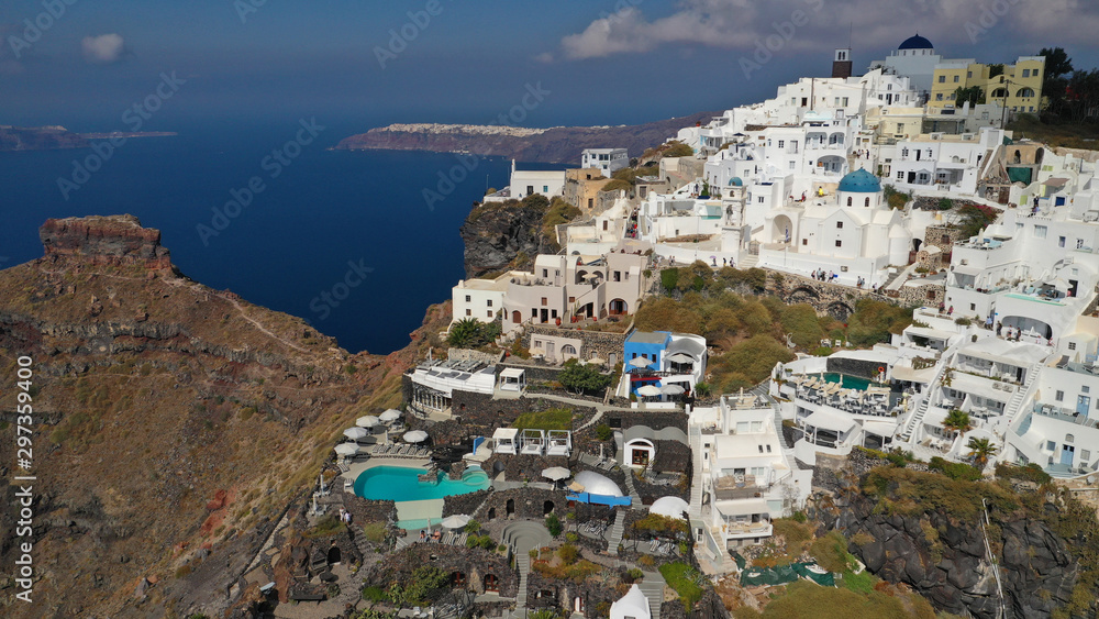 Aerial drone photo of iconic picturesque village of Imerovigli built on top of steep hill with amazing views to Caldera and Santorini island, Cyclades, Greece
