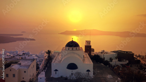 Aerial drone photo of beautiful sunset over picturesque village of Imerovigli and Skaros rock with beautiful golden colours, Santorini island, Cyclades, Greece