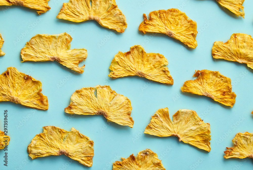 Dried pineapple on colored background. Pattern of a pineapple frips. Healthy eating Dried pineapple on colored background. Pattern of a pineapple frips. Healthy eating