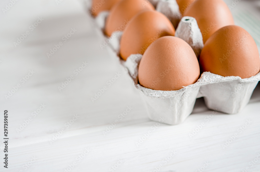 Large brown chicken eggs lie in an eco-friendly cardboard egg tray Large brown chicken eggs lie in an eco-friendly cardboard egg tray