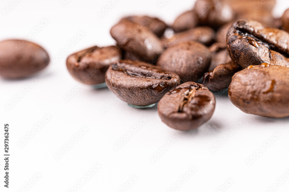 Macro view of roasted coffee beans on white background Macro view of roasted coffee beans on white background