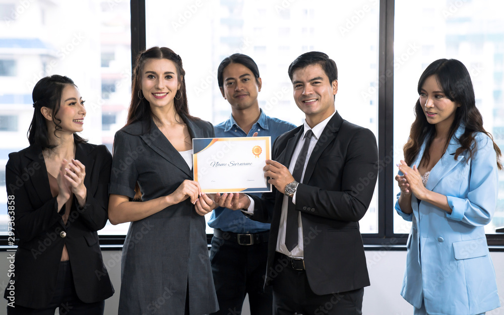 The business executive was satisfied with the work of the female employee and gave her a certificate of excellence. The business executive was satisfied with the work of the female employee and gave her a certificate of excellence.