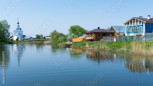 Suzdal. Wooden houses on the banks of the river Kamenka.
