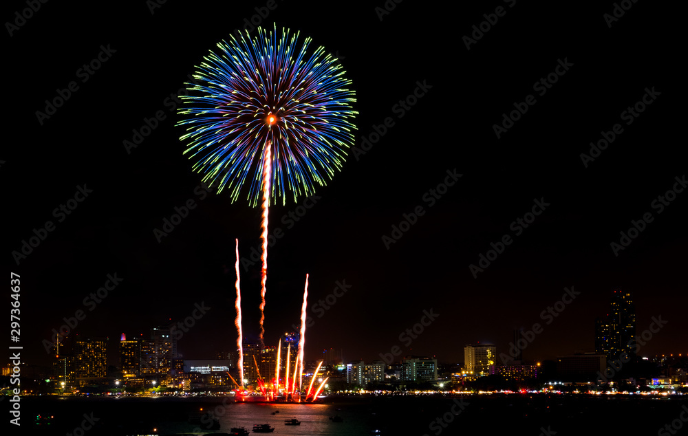 Happy new year fireworks over cityscape at night.holiday celebration festival Happy new year fireworks over cityscape at night.holiday celebration festival