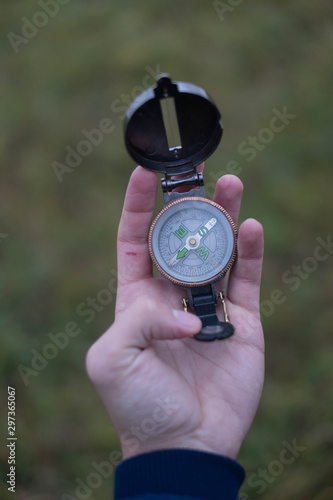 man holds a compass in his hand. man wathing compass holding in his hands