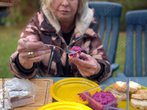 woman spreading beetrot on a bread, photo