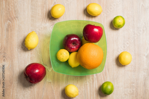 Fototapeta Naklejka Na Ścianę i Meble -  Fruit studio image. Bowl of fruit. Set of citrus fruits and red apples.