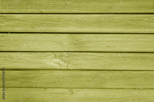 Old grungy wooden planks background in yellow color.