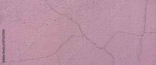 Old light pink plaster wall texture background. Abstract painted cracked wall surface