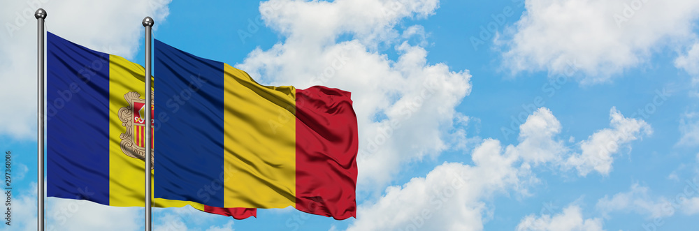 Obraz premium Andorra and Romania flag waving in the wind against white cloudy blue sky together. Diplomacy concept, international relations.