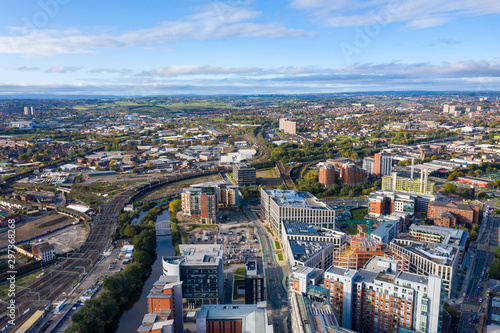 Aerial photo of the Leeds town centre in the UK showing train tracks along the city centre