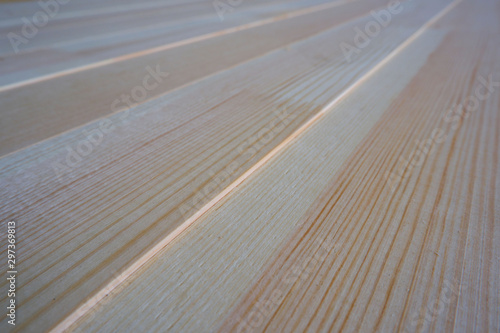 Top close up view of stack of three-layer wooden glued laminated timber beams from pine finger joint spliced boards