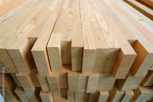 End-top close up view of stack of three-layer wooden glued laminated timber beams from pine finger joint spliced boards