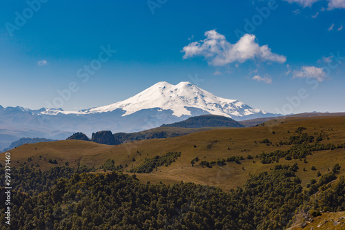 View of the peaks of Mount Elbrus with clouds in the sky. © olgapkurguzova