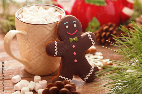 Wallpaper Mural Gingerbread man and hot chocolate with marshmallows, on the background of Christmas tree branches on a wooden table Torontodigital.ca