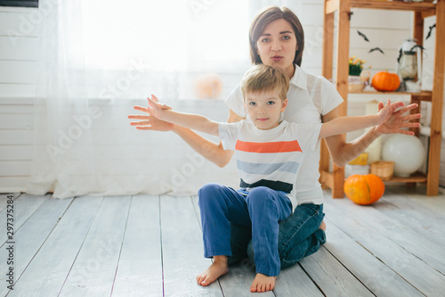 Mom and her son play in the halloween room. Happy Halloween concept photo