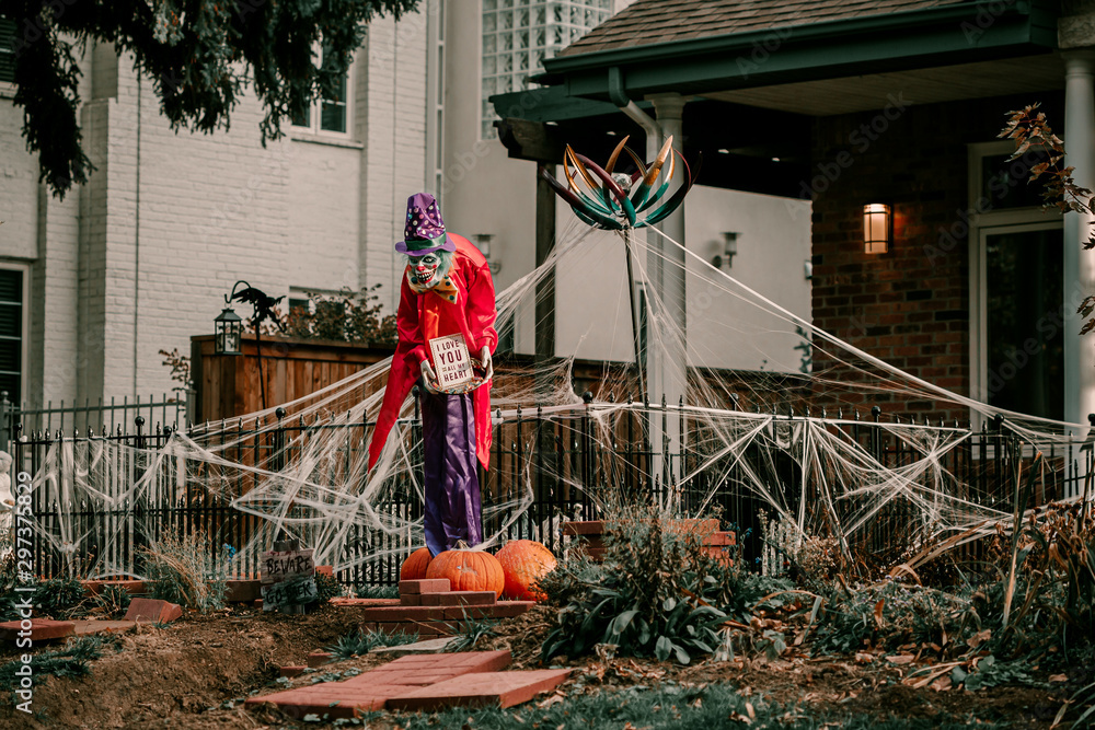 Scary spooky Halloween house decorations. Halloween season. October 31  spooky day. Trick or treat kids holiday. Scary witch, ghost, spiders,  clown, pumpkins, skeleton decor. Coffin on the grass. Stock Photo | Adobe  Stock