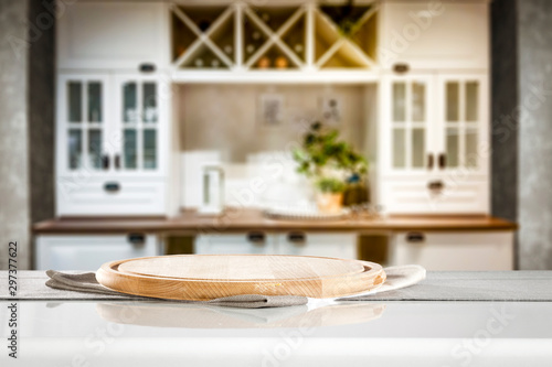 Kitchen table top with kitchen accessorries and empty space for you products or decorations. Blurred kitchen background. photo