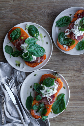 Roasted pumpkin with ricotta cheese  serrano ham  spinach and onion. Food photography Food. Top view.