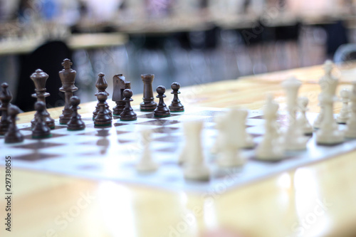 Black and white Chess pieces. Moving the pieces in chess game. Beautiful chess combinations. Stock photo.