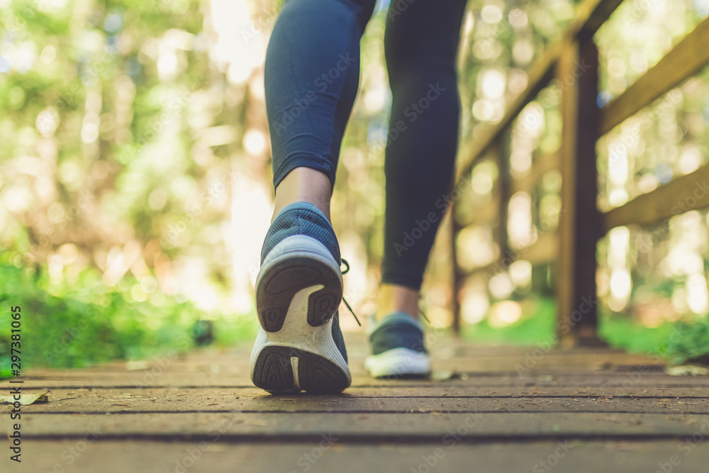 Woman runner feet walking in nature. Close up on shoes. Healthy lifestyle fitness concept. Woman runner feet walking in nature. Close up on shoes. Healthy lifestyle fitness concept.