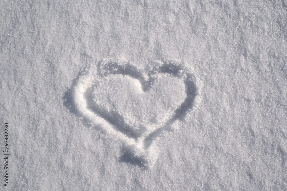 Symbol of heart, painted on the fresh white snow Symbol of heart, painted on the fresh white snow