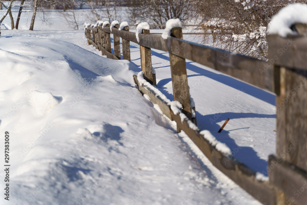 Wooden fence with snow in winter time Wooden fence with snow in winter time
