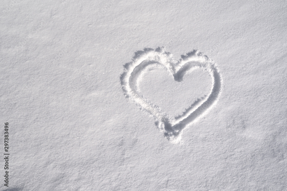 Symbol of heart, painted on the fresh white snow Symbol of heart, painted on the fresh white snow