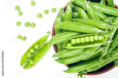 Wallpaper Mural green peas in pods.  in a clay plate view from above on a white background Torontodigital.ca