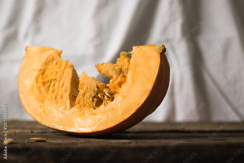 Fresh pumpkin on the table from old boards. Horizontal orientation and white background.