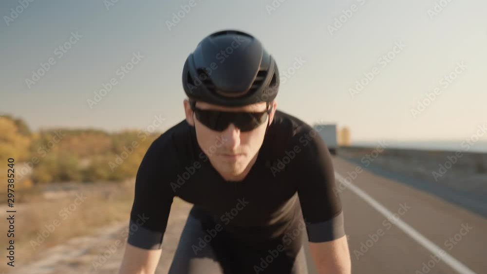 Cycling Triathlete Cyclist For Ironman Race.Athlete Professional Fit Man On Triathlon Bicycle.Cyclist In Helmet Riding On Sunset On Triathlon Time Trial Bicycle.Cycling On Sunset Time Or Dusk. Cycling Triathlete Cyclist For Ironman Race.Athlete Professional Fit Man On Triathlon Bicycle.Cyclist In Helmet Riding On Sunset On Triathlon Time Trial Bicycle.Cycling On Sunset Time Or Dusk.