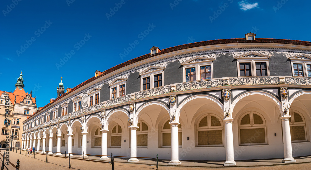 Panoramic view of historical center and colorful painted buildings (Haus der Kathedrale) in downtown of Dresden in summer with blue sky, Germany