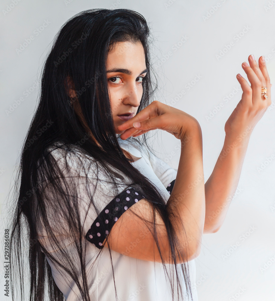 Portrait of charming middle-eastern woman. Side view of pretty beautiful  female in white t-shirt Stock Photo | Adobe Stock