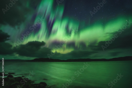 Northern Lights  Aurora Borealis in Kola Peninsula at night sky illuminated green. Murmansk region  Russia