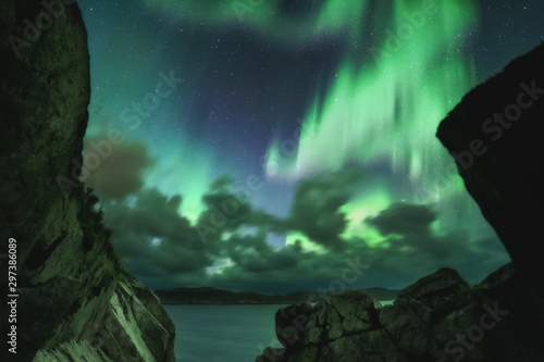 Northern Lights, Aurora Borealis in Kola Peninsula at night sky illuminated green. Murmansk region, Russia photo