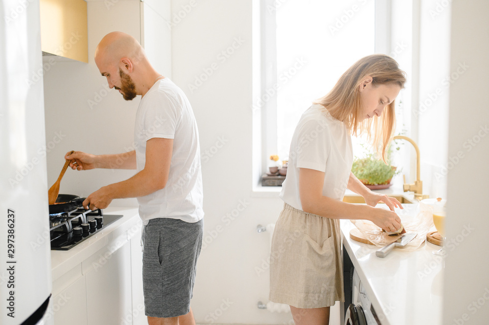 husband and wife cooking in the kitchen