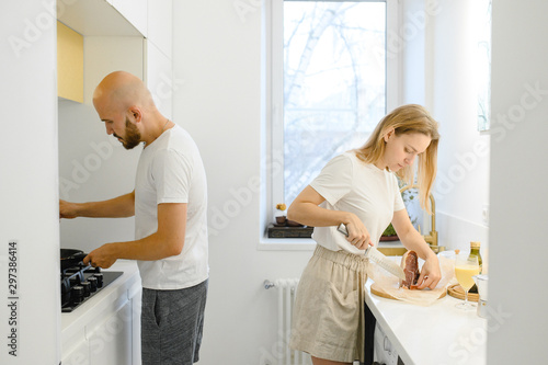 husband and wife cooking in the kitchen