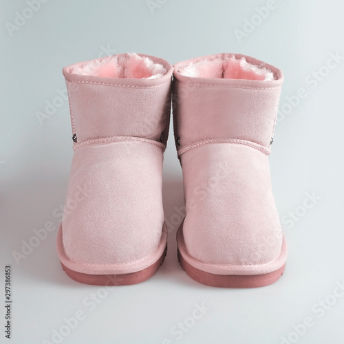 winter pink boots on blue background