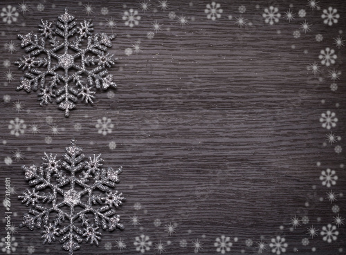 Christmas background with snowflakes on wooden texture with copy space